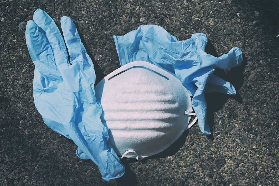 Surgical mask and gloves on the ground